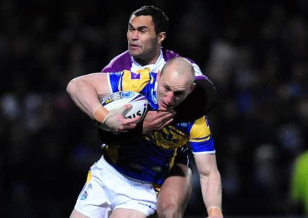 Leeds Rhinos' Carl Ablett is tackled by Melbourne Storm's Justin O'Neill