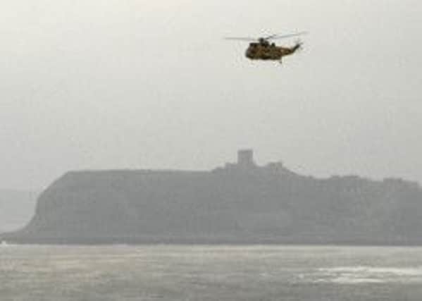 The scene in Scarborough, where the RNLI and RAF Sea King have been deployed to search for a missing angler off Burniston Cliffs. Picture: Ross Parry Agency
