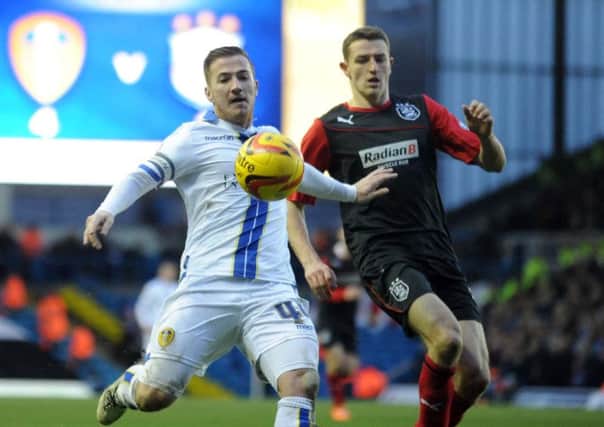 Leeds United striker Ross McCormack is challenged by Murray Wallace.
