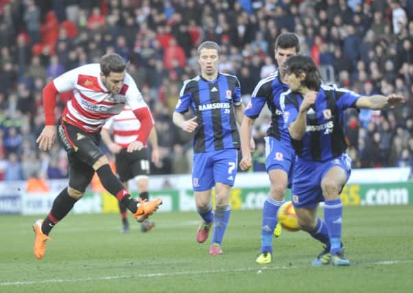 Rovers' Billy Sharp lets fly against Boro's  George Friend.