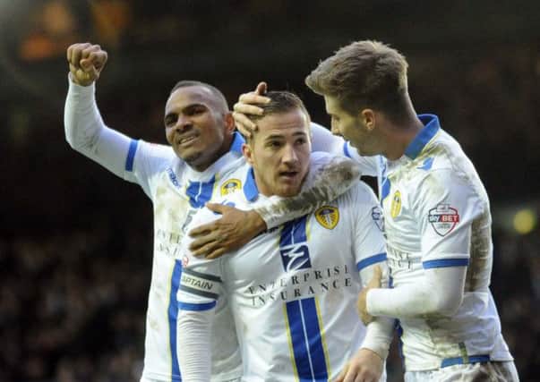 Leeds United striker Ross McCormack is congratulated by Luke Murphy and Rodolph Austin after scoring his hat-trick.