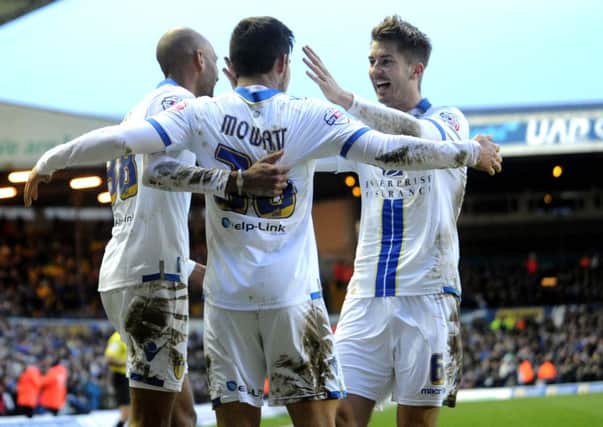 Leeds United player Alex Mowatt is congratualted by his teammates.