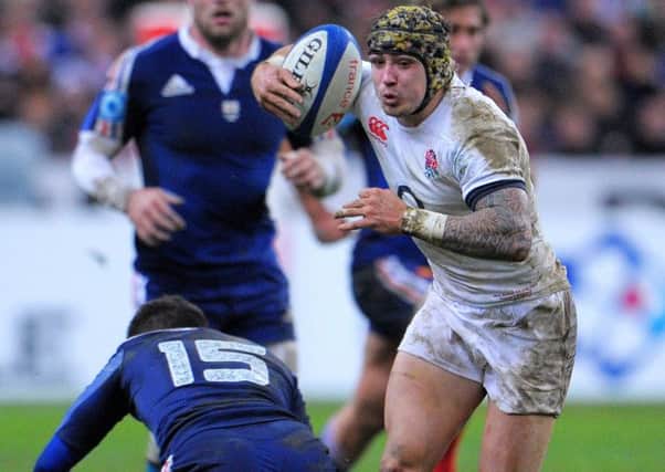 England's Jack Nowell sidesteps the tackle of France's Brice Dulin