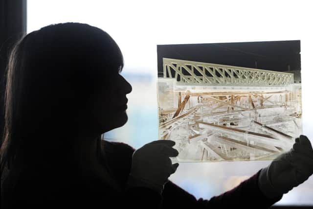 Caitlin Smaldon with a glass plate negative of the building of the canal in the town.  Picture by Tony Johnson