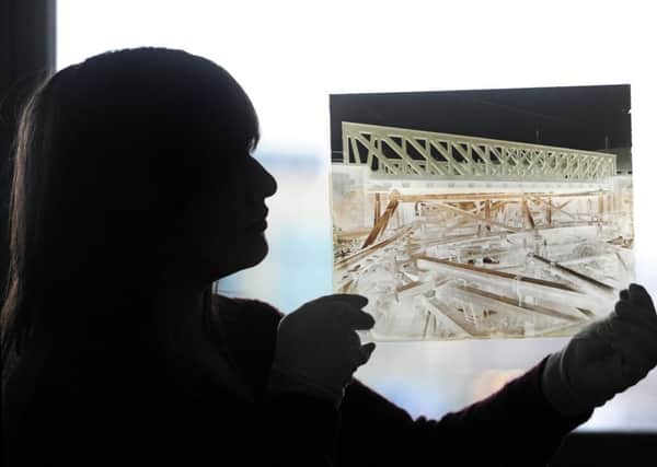 Caitlin Smaldon with a glass plate negative of the building of the canal in the town.  Picture by Tony Johnson
