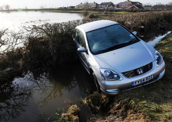 A car lies in a dyke in Sluice Road, South Ferriby following a tidal surge.  Picture by Bruce Rollinson