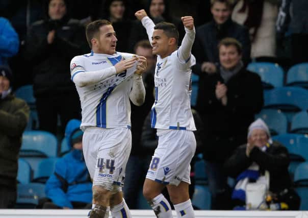 Leeds United's Ross Mccormack (left) celebrates scoring his sides third goal with and Rodolph Austin
