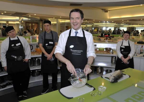 George Osborne joins trainee chefs at a cookery school during a visit to the Dean Clough Mills in Halifax