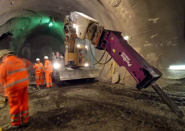 An excavators with an articulated boom, in one of the Crossrail tunnels under construction 35 metres below the streets of Whitechapel, east London