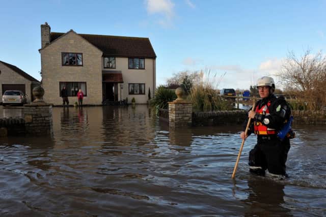 Emergency workers in Moorland, Somerset, after residents were advised to evacuate after flood defences were breached overnight.
