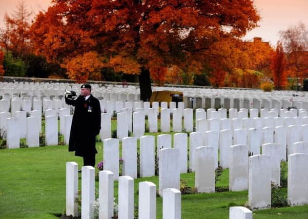 Derek Webb, who was a bugler in the Royal Green Jackets, plays the Last Post for his Great Uncle Albert Webb, who has his name engraved among the 11953 Commonwealth soldiers at Tyne Cot cemetery near Ypres, Belgium.