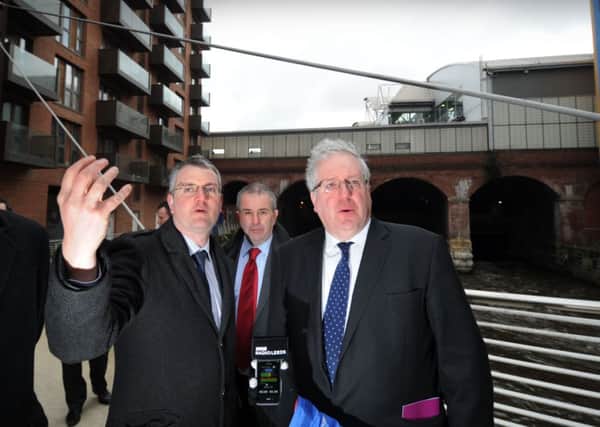 Transport Secretary Patrick McLoughlin (right) on the footbridge at Leeds Station with rail officials