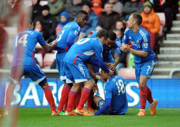 Hull's Nikica Jelavic is mobbed by team mates after his goal.