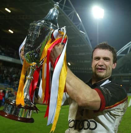 Bradford Bulls Jamie Peacock holds the trophy after his team's win against Penrith Panthers in The World Club Challenge 2004 at the Alfred McAlpine stadium in Huddersfield Friday 13th February, 2004. PA Photo: Martin Rickett.