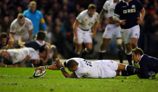 NICE START: England's Luther Burrell touches down to score the first try of the game at Murrayfield. Picture: Dave Thompson.