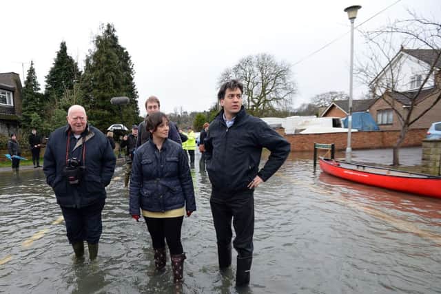 Labour leader Ed Miliband (right) and Victoria Groulef (centre), Labour's Parliamentary Candidate for Reading West, during a visit to the view recent flooding in Purley on Thames in Berkshire.