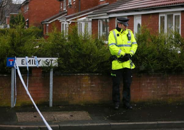 A police officer stand at the corner of Emily Street in Blackburn, Lancashire, after an eleven month old baby girl died after she was mauled by a pet dog.