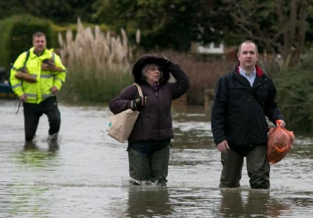 Residents walk through flood water in Wraysbury, Berkshire.