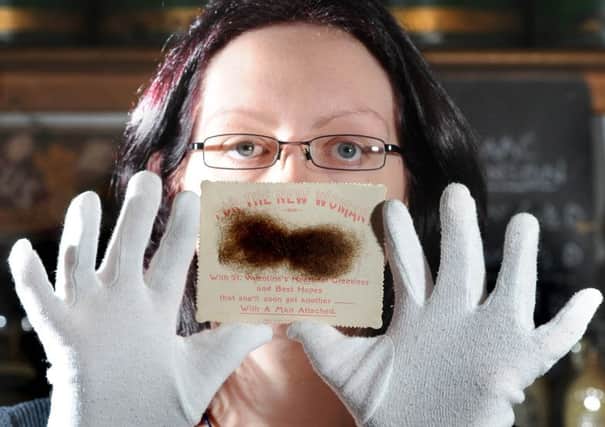 Faye Prior, collections facillitator at the York Castle Museum,  holds what's believed to be the worst Valentine's Day card in history containing human hair.
