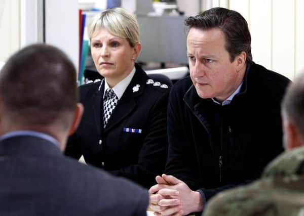 David Cameron talks to representatives from the emergency services, military, Network Rail and power companies at Bispham Fire Station, Blackpool