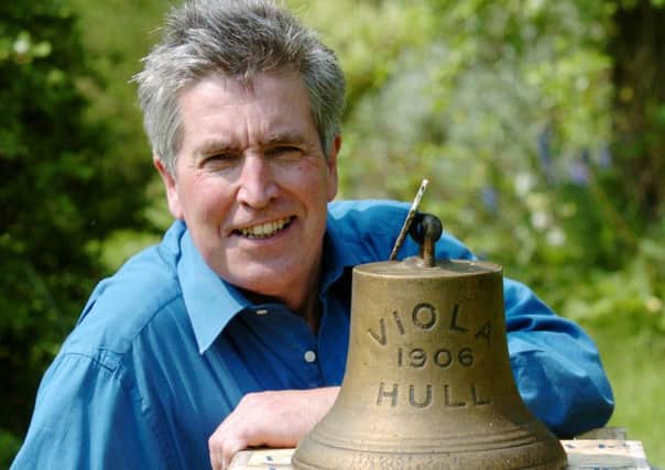 Maritime historian Robb Robinson with the ship's bell from the steam trawler Viola