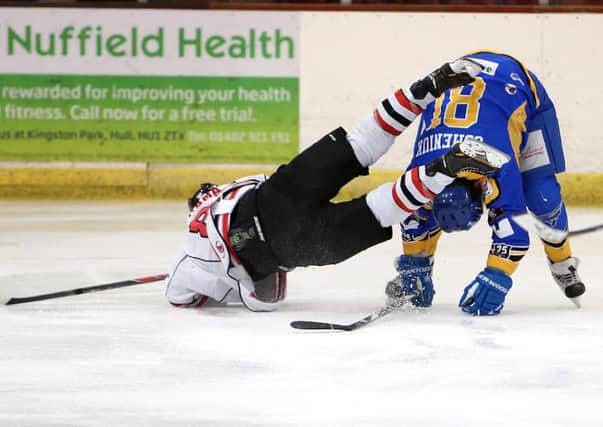 OVER YOU GO: A Cardiff Devils forward takes a tumble over Hull's Pavel Gomeniuk during their Elite League clash on Saturday night. Picture: Arthur Foster.