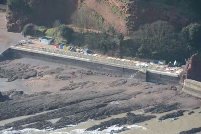 Aerial views of damaged beach huts in Teignmouth.