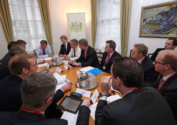 Minister of State for Policy Oliver Letwin (top centre) and MP Jo Johnson (top centre right) host a meeting with members of the UK Insurance companies to discuss the response to the continuing flooding