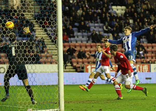 TOUGH NIGHT: Wigan's Martyn Waghorn scores his side's second goal against Barnsley at the DW Stadium. Picture: Lynne Cameron/PA.
