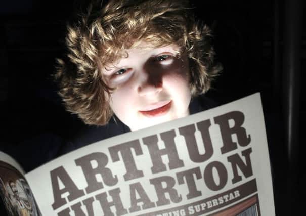 A youngster reading about the exploits of Arthur Wharton in the newly released story comic of his life.