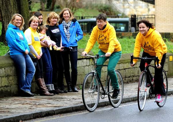 Vicky Griffin (right) Organiser of the Marie Curie  'Le Coast to Coast 2014' challenge  with Robyn Carter on bicycles  with some of the participants  at the launch event in York