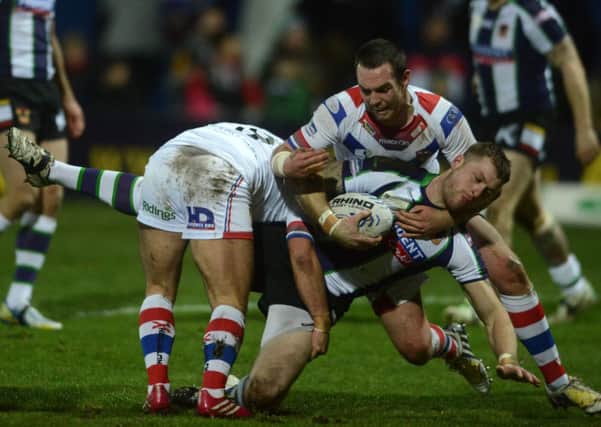 GOING NOWHERE: Bradford's Adam Sidlow is held by Wakefield's Paul McShane and Daniel Smith. Picture Bruce Rollinson