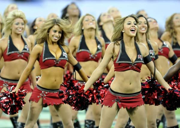 Cheerleaders entertain the crowd before the start of an NFL match at Wembley Stadium, London.