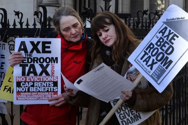 Protest groups against the government's "bedroom tax" demonstrate outside the High Court in London.