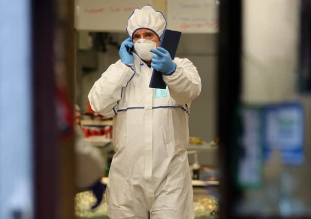 Police forensic officers inside the Bismillah Food Store in Rotherham following the murder of shopkeeper Parvaiz Iqbal. Picture: Ross Parry Agency