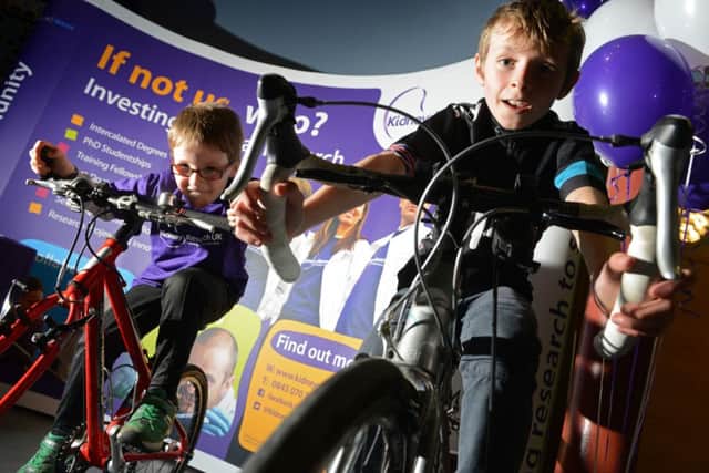Daniel Rogers, 6, and Oscar Ballantyne, 10, race each other on static bikes on the Kidney Research stall at the 'We Love Le Tour de France' event at Leeds City Museum. Picture Bruce Rollinson