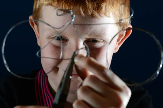 Sam Barraclough, 8, making a wire bike during one of the art sessions at We Love Le Tour de France event at Leeds City Museum.