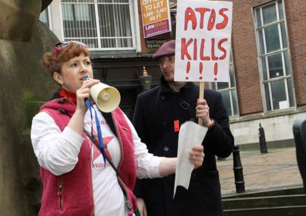 Protesters campaigning against Atos outside a benefits office