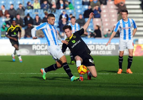 Wednesday's Sam Hutchinson tackles Town's Nahki Wells. Picture by Tony Johnson