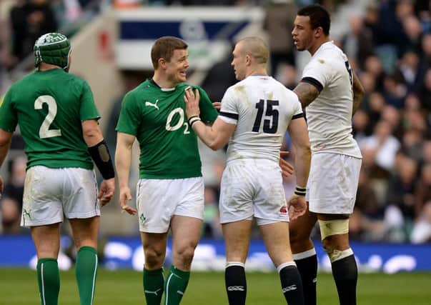 England's Mike Brown (2nd right) has words with Ireland's Brian O'Driscoll at Twickenham.