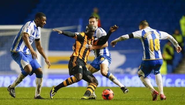 Hull City's Yannick Sagbo battles against the Brighton defence.