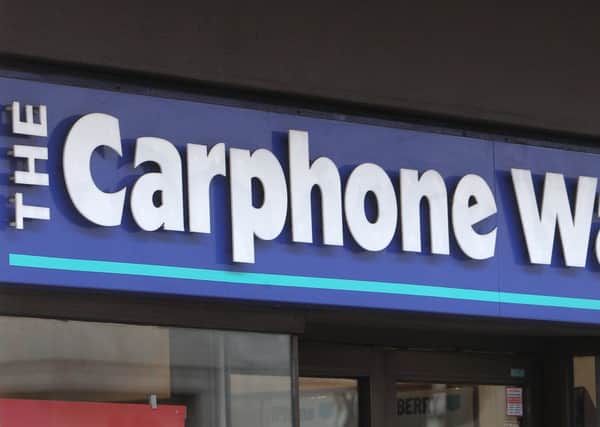 The owner of PC World and Currys has revealed it is in talks with the mobile phone retailer about a potential merger.