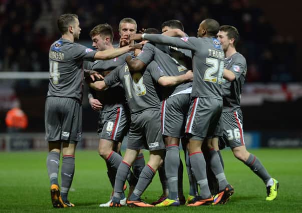 Ben Pringle is surrounded by team mates after Rotherham's second goal.