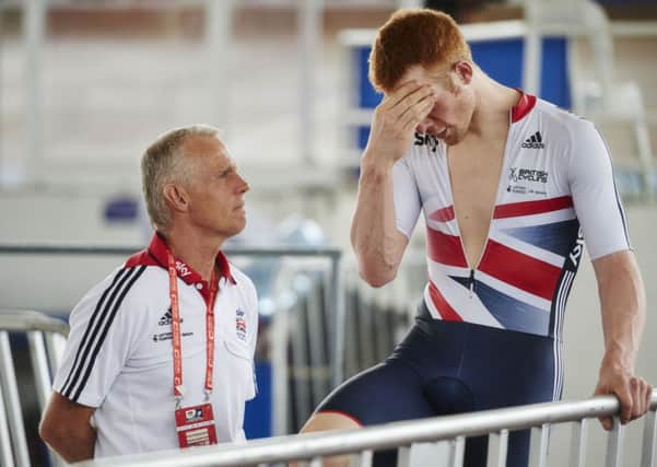 Britain's Ed Clancy talks with head coach Shane Sutton during a training session before the 2014 UCI Track Cycling World Championships in Cali, Colombia.