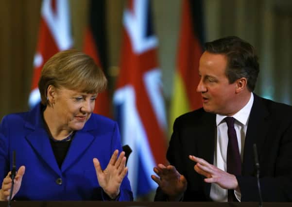 David Cameron speaks during a news conference with German Chancellor Angela Merkel.