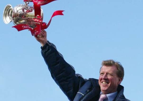 Middlesbrough manager Steve McLaren with the Carling Cup, as the team ride an open top bus during the victory parade in Middlesbrough, Sunday March 7, 2004.