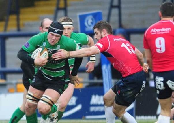 Leeds Carnegie's 
Ryan Burrows charges through the Scottish defence