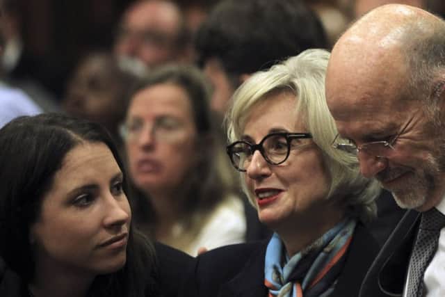 Oscar Pistorius with sister Aimee, aunt Lois, and uncle Arnold (below) wait for the start of his trial