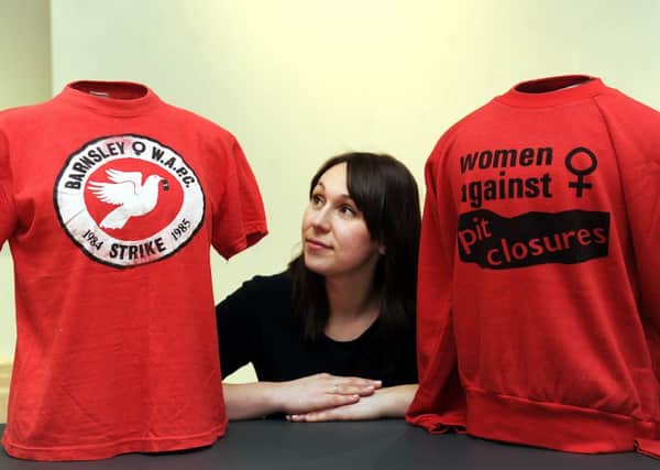 Museum curator Jemma Conway with shirts worn at the time of the 1984-85 miners strike