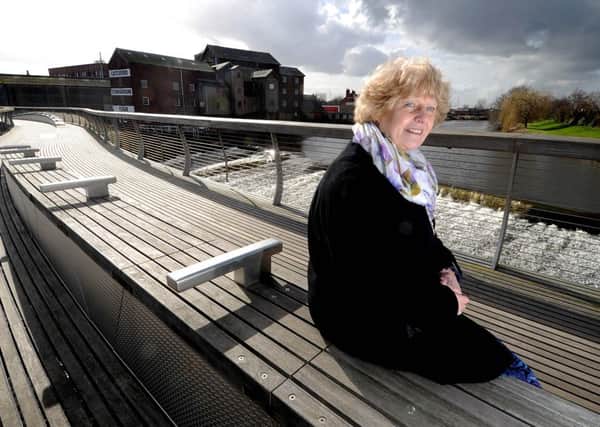Alison Drake, from Castleford Heritage Trust, on the award winning pedestrian bridge over the River Aire at Castleford, close to the Queens Mill.
